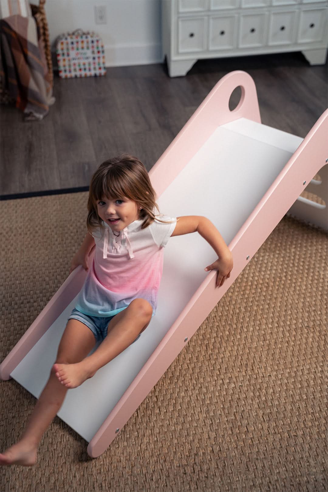 Toddler going down the Avenlur Manuka indoor slide for toddlers