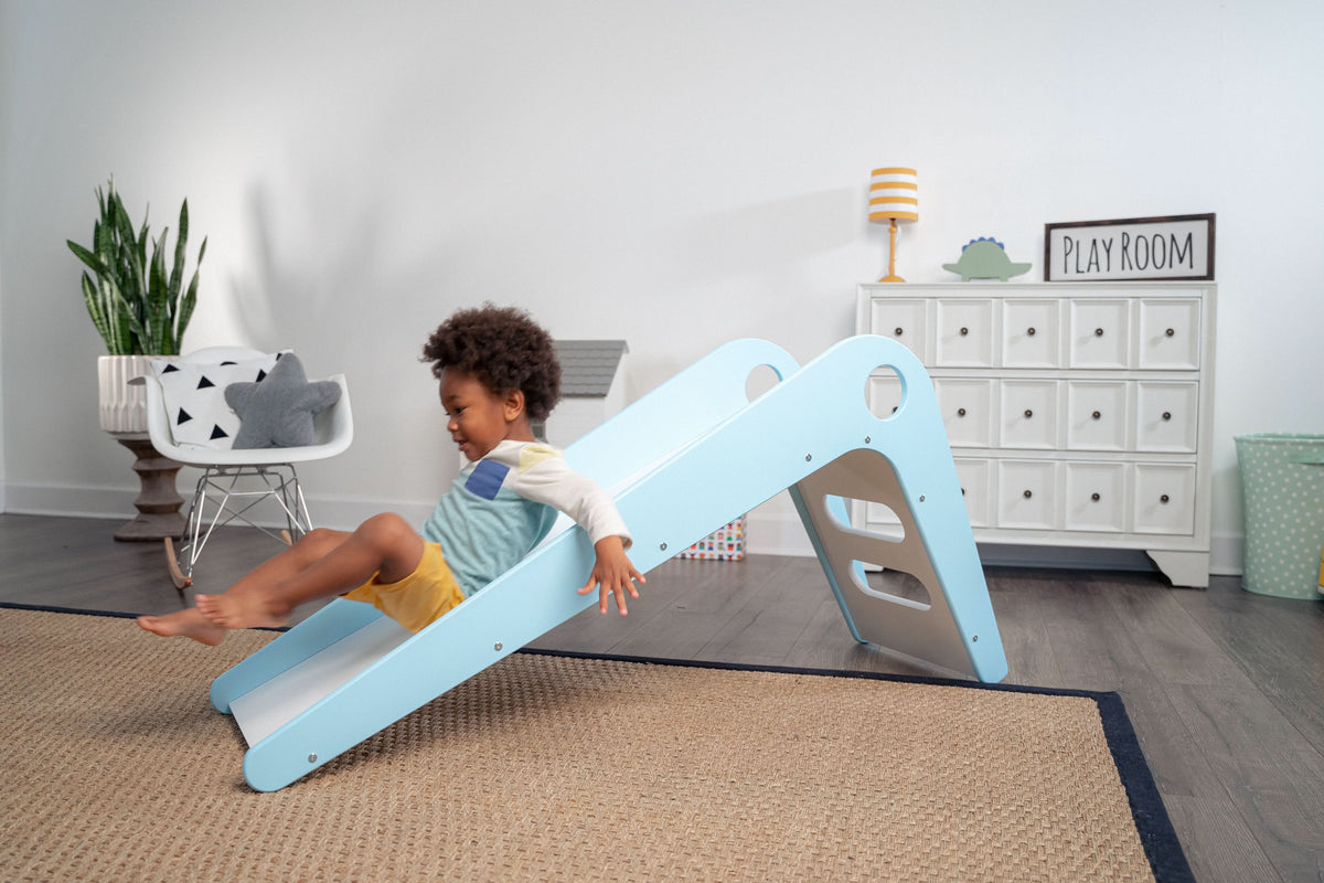 Avenlur Manuka wooden toddler slide indoors in a bright living room