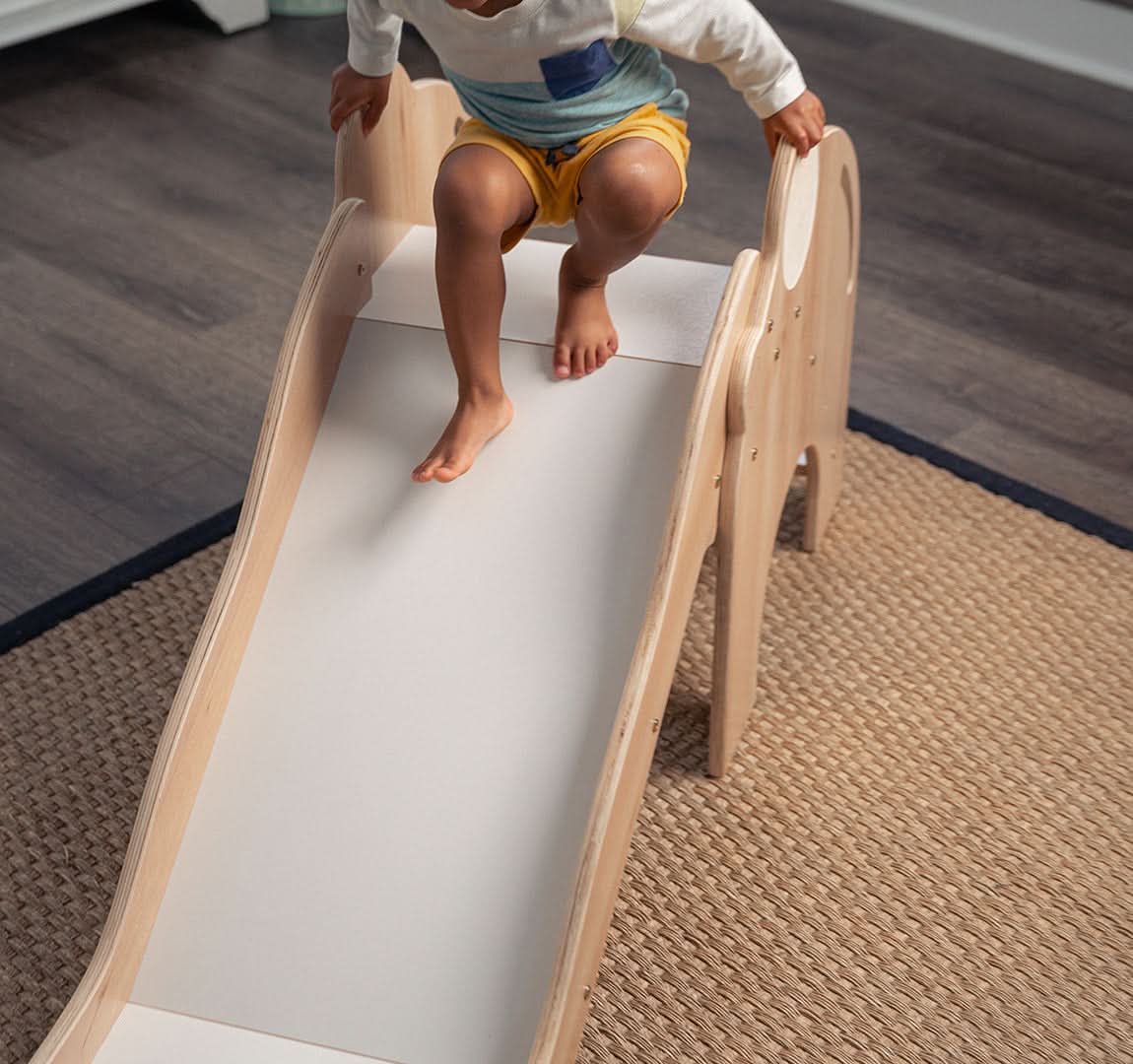Toddler going down the Avenlur Nima indoor slide