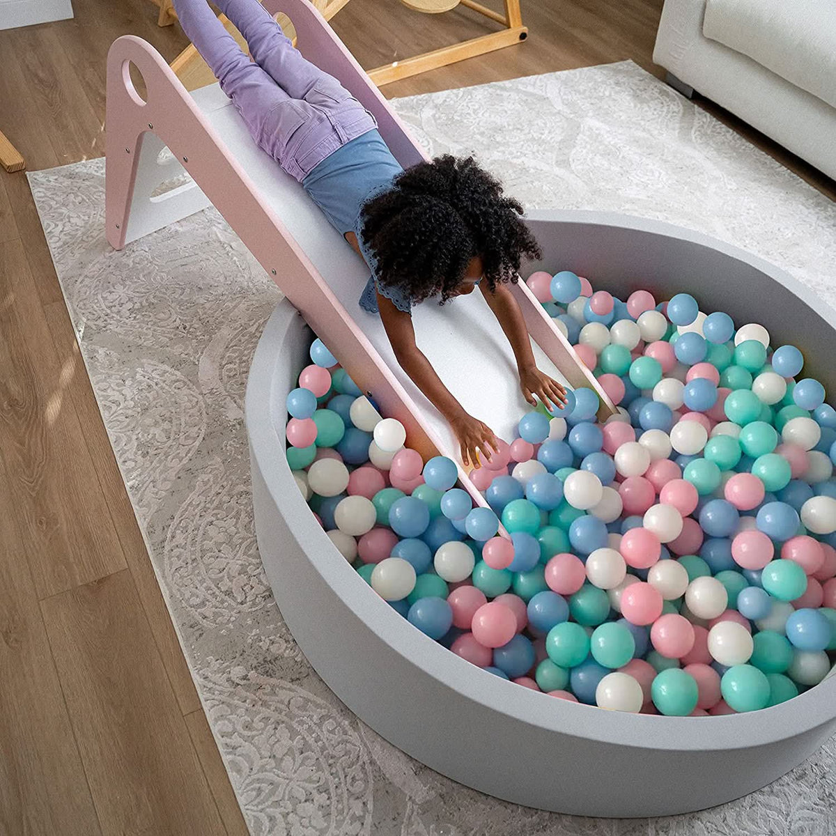 Toddler playing in the Avenlur soft foam ball pit