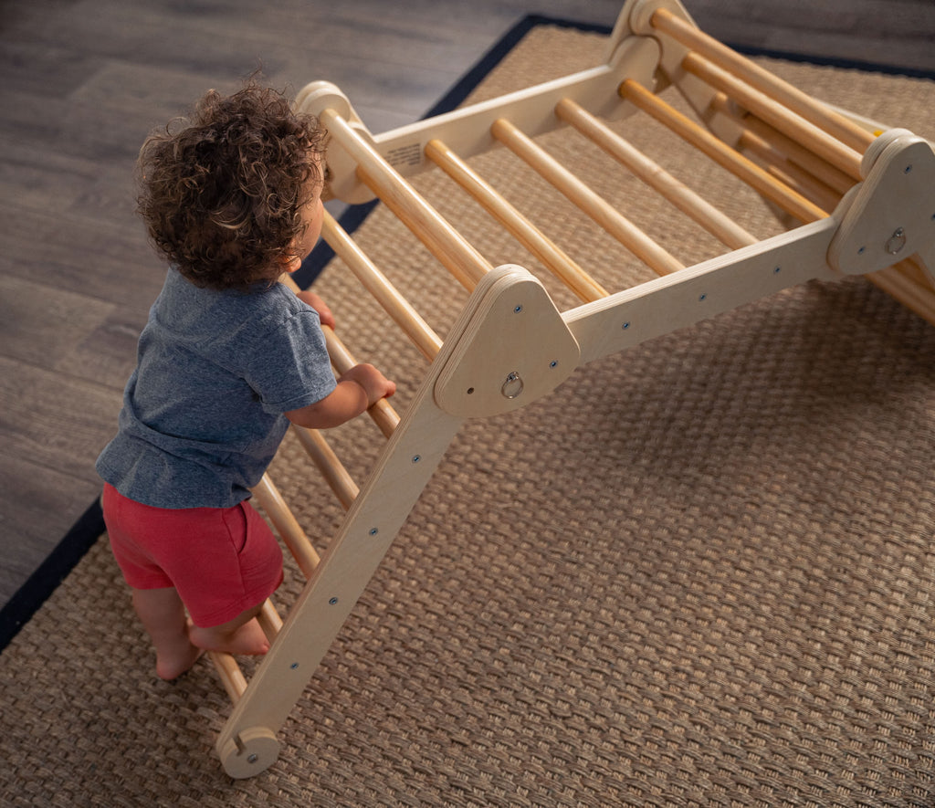 Toddler climbing the Avenlur Vicus triangle ladder
