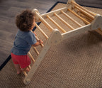 Toddler climbing the Avenlur Vicus triangle ladder