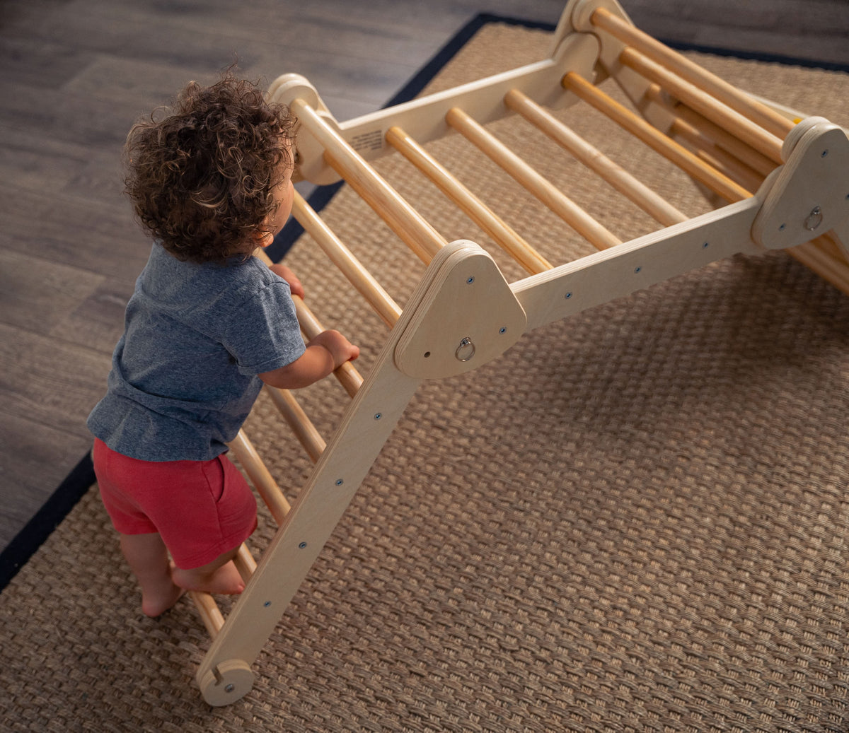 Toddler climbing the Avenlur Vicus triangle ladder