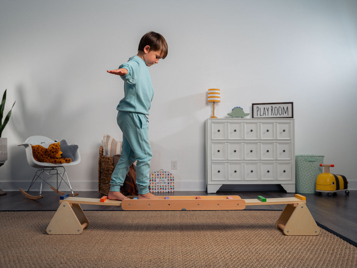 Child walking the Avenlur Willow balance beam for kids indoors