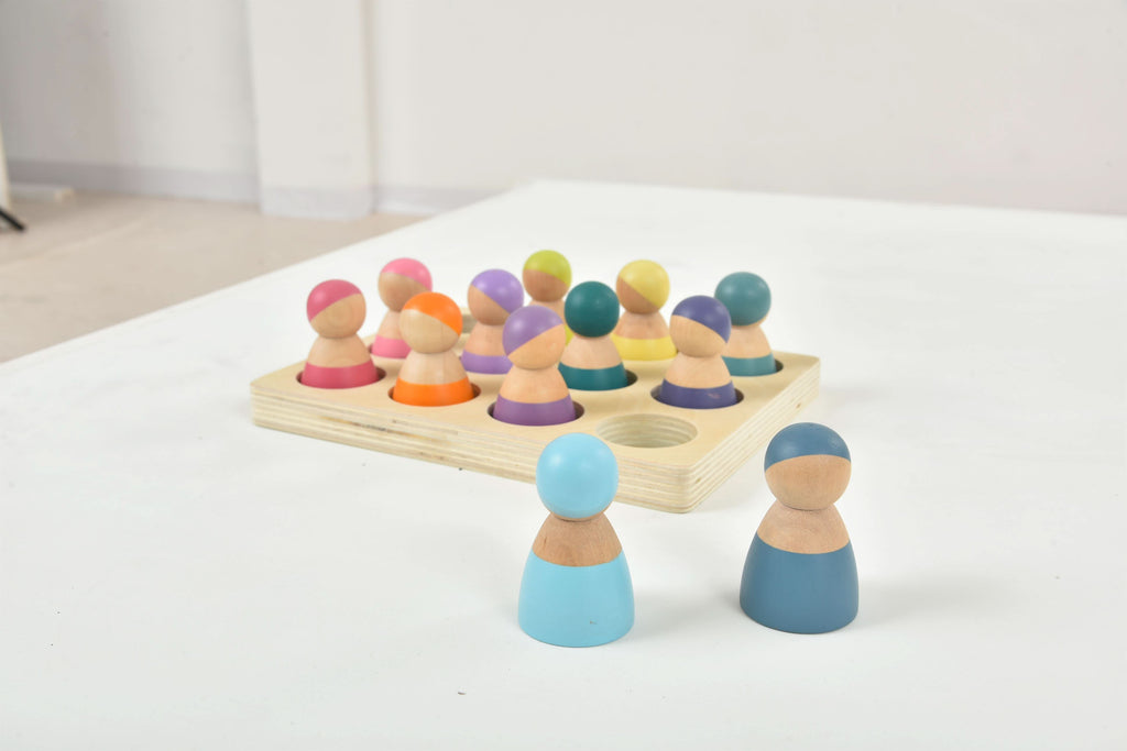 Close up of Avenlur wooden peg dolls with painted faces