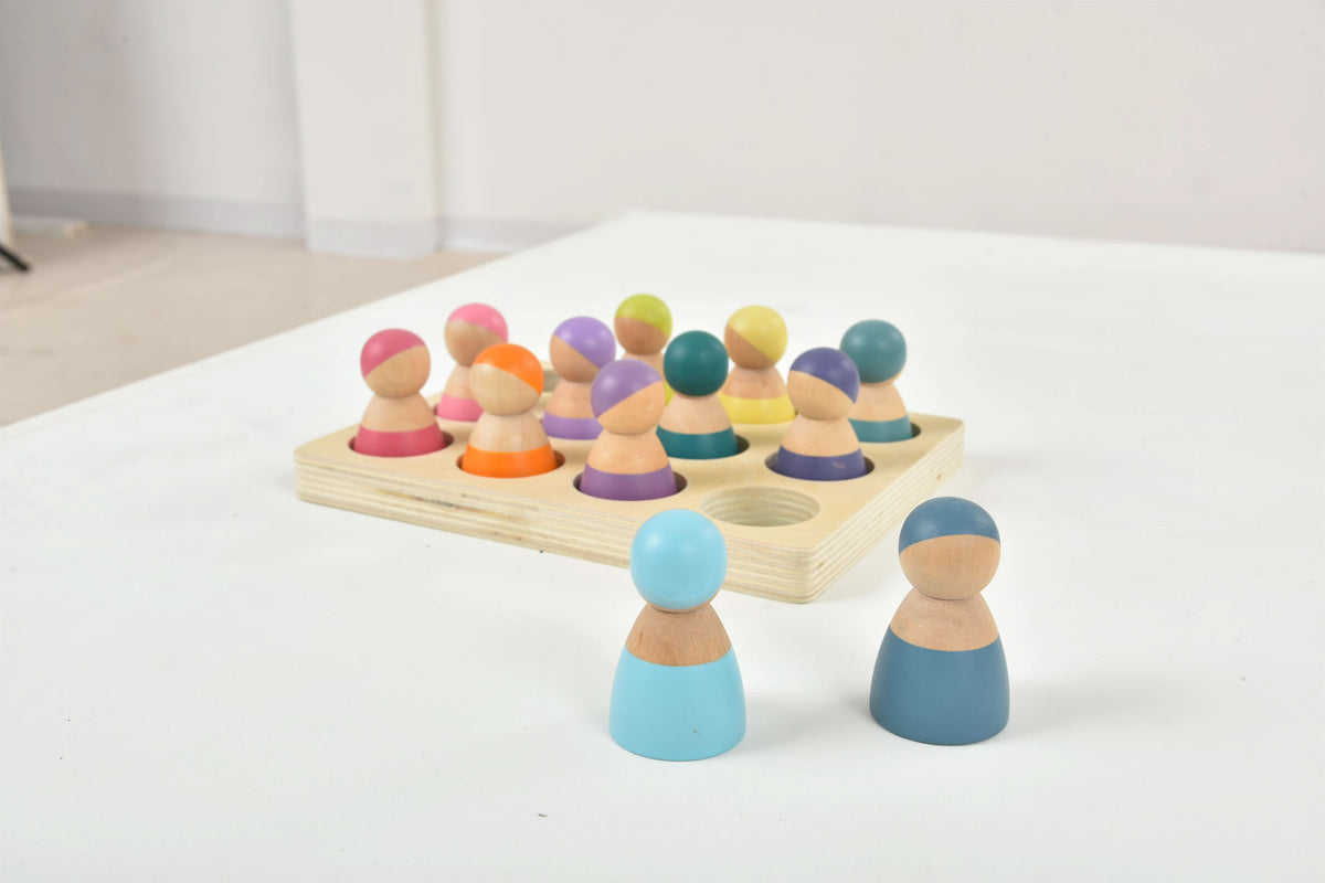 Close up of Avenlur wooden peg dolls with painted faces