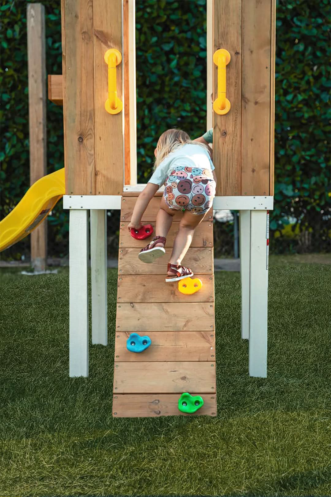 Close up of Girl on Rock Climbing Wall of Avenlur's Forrest Swing Set - Side View