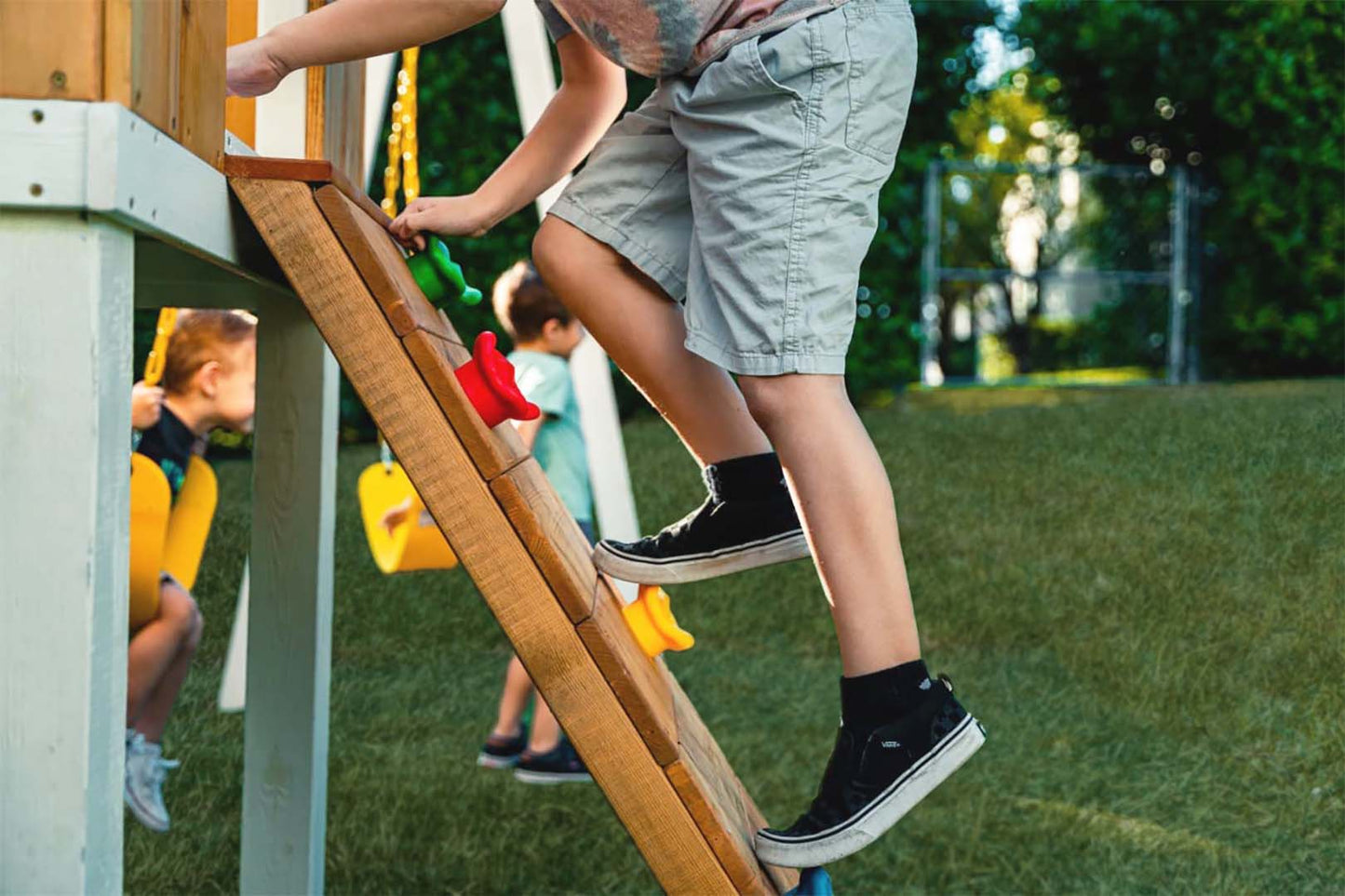 Close Up of Child's Feet on Rock Wall Climber on Avenlur's Forrest Swing Set